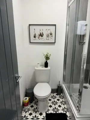 a small bathroom with a toilet and a shower at 3BR Accommodation in St Helens - Sleeps 6 in Saint Helens