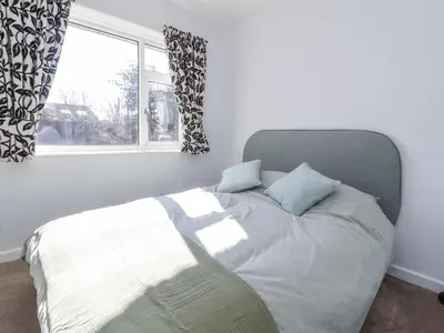 a bed with two pillows and a window in a bedroom at 38 Clive Avenue in Lytham St Annes