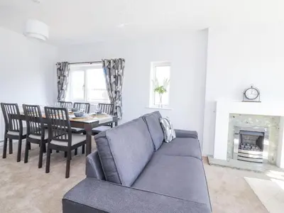 a living room with a couch and a dining room table at 38 Clive Avenue in Lytham St Annes