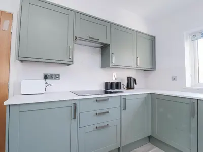 a kitchen with white cabinets and a sink at 38 Clive Avenue in Lytham St Annes