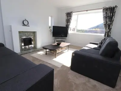 a living room with a couch and a fireplace at 38 Clive Avenue in Lytham St Annes
