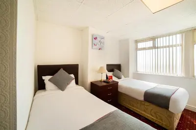 a bedroom with two beds and a window at HOTEL BLUE OCEAN - Call For Cheap Prices - Check In Until 3AM in Blackpool