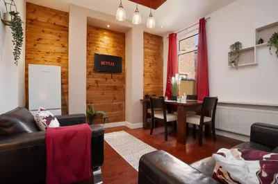 a living room with a table and a dining room at 5-Bedroom House Long Stays Contractors Liverpool Hinkley Homes in Liverpool