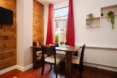 a dining room with a table and chairs and a window at 5-Bedroom House Long Stays Contractors Liverpool Hinkley Homes in Liverpool