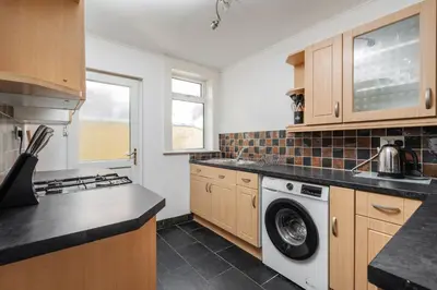 a kitchen with a washer and dryer at 5-Bedroom House Long Stays Contractors Liverpool Hinkley Homes in Liverpool