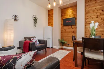 a living room with couches and a table and a tv at 5-Bedroom House Long Stays Contractors Liverpool Hinkley Homes in Liverpool