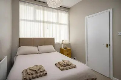 a bedroom with a bed with towels on it at Hotel Sofia Blackpool in Blackpool