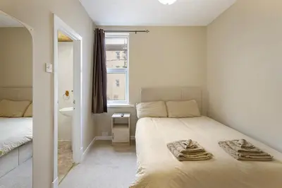 a small bedroom with a bed and a window at Hotel Sofia Blackpool in Blackpool
