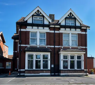 a red brick house with white windows at Hotel Sofia Blackpool in Blackpool