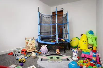 a childs room with toys and a crib at Hotel Sofia Blackpool in Blackpool