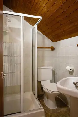 a bathroom with a toilet and a shower and a sink at Hotel Sofia Blackpool in Blackpool