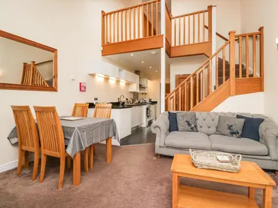 a living room with a table and a couch at 7 Sandpiper in Carnforth