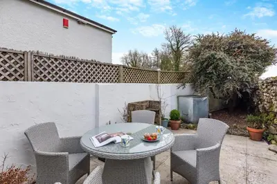 a patio with a table and chairs and a fence at 2 Bed in Field Broughton oc-l31021 in Cartmel