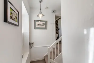 a white staircase with a pendant light in a house at 2 Bed in Field Broughton oc-l31021 in Cartmel