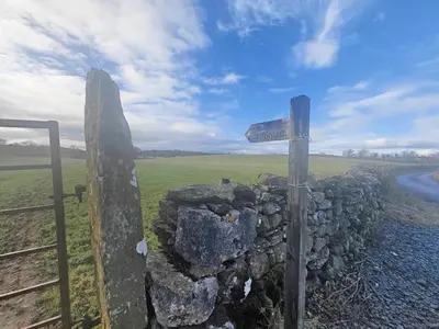 a sign on a stone wall next to a road at 2 Bed in Field Broughton oc-l31021 in Cartmel