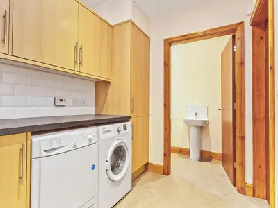a laundry room with a washer and dryer at Tower Cottage in Arnside