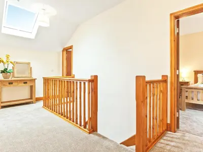 a living room with a staircase and a stair case at Tower Cottage in Arnside