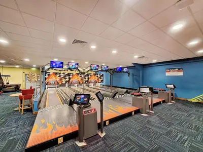 a bowling alley with pins and a game room at Tower Cottage in Arnside