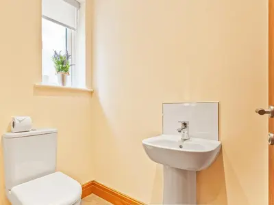 a bathroom with a toilet and a sink at Pier Cottage in Arnside