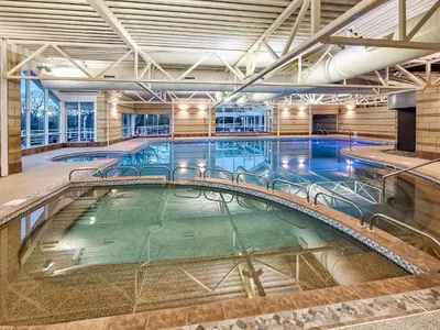 a large indoor swimming pool in a building at Pier Cottage in Arnside