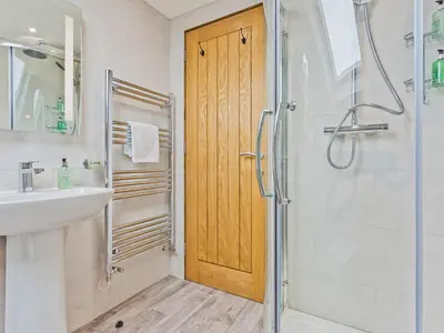 a bathroom with a shower and a sink at Keer Cottage in Carnforth
