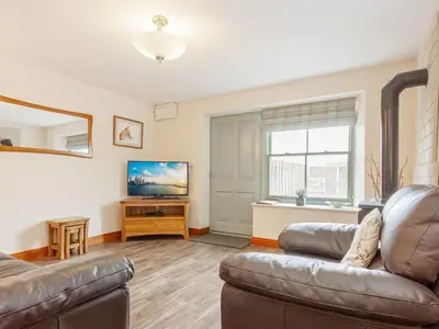 a living room with a couch and a television at The Pepperpot - Uk49156 in Silverdale
