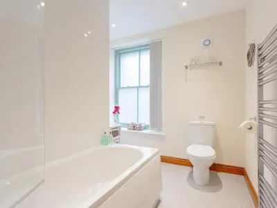 a white bathroom with a tub and a toilet at The Pepperpot - Uk49156 in Silverdale