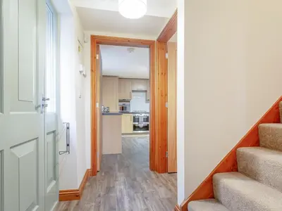 a hallway with stairs leading to a kitchen at The Pepperpot - Uk49156 in Silverdale