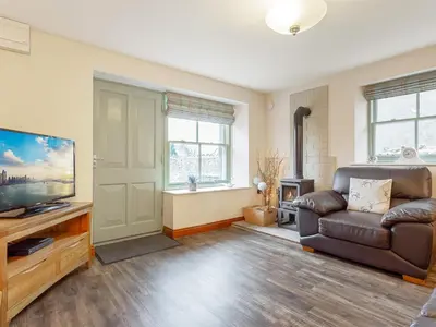 a living room with a couch and a flat screen tv at The Pepperpot - Uk49156 in Silverdale