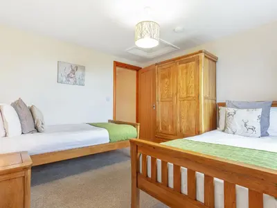 a bedroom with two beds and a wooden cabinet at The Knott - Uk49161 in Silverdale