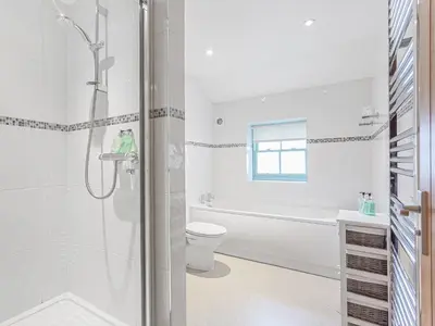 a white bathroom with a shower and a toilet at The Knott - Uk49161 in Silverdale