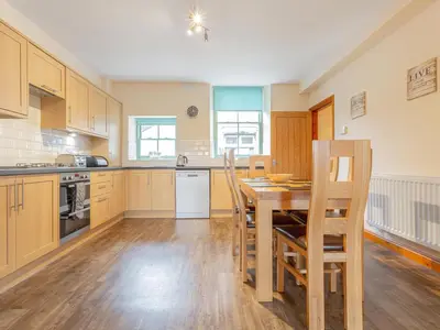a large kitchen with a wooden table and chairs at The Knott - Uk49161 in Silverdale