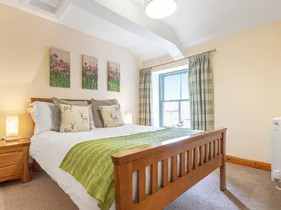 a bedroom with a large bed and a window at The Knott - Uk49161 in Silverdale