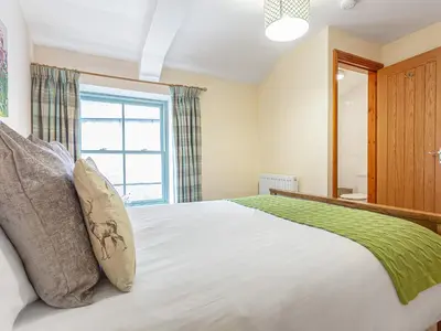 a bedroom with a large bed and a window at The Knott - Uk49161 in Silverdale