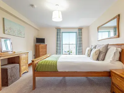 a bedroom with a large bed and a television at The Knott - Uk49161 in Silverdale