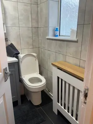 a small bathroom with a toilet and a window at Knotty Ash - 3 Beds - Sleeps 6 - On-Site Parking in Liverpool