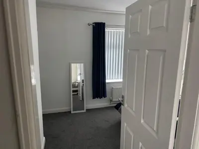 an empty room with a door and a mirror at Knotty Ash - 3 Beds - Sleeps 6 - On-Site Parking in Liverpool