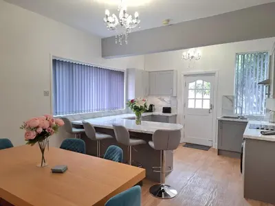 a kitchen and dining room with a table and chairs at Amazing Central House in Blackpool