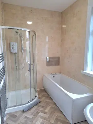 a bathroom with a shower and a tub and a sink at Amazing Central House in Blackpool