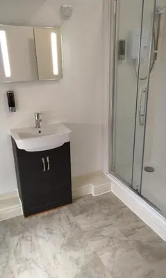 a bathroom with a sink and a shower at Stratford House Holiday Apartments in Blackpool