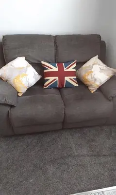 a couch with four pillows with british flags on it at Stratford House Holiday Apartments in Blackpool