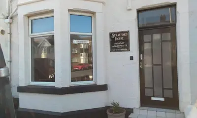 a building with a sign on the side of it at Stratford House Holiday Apartments in Blackpool