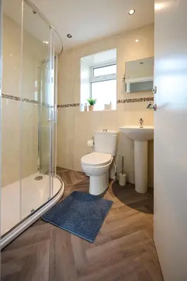 a bathroom with a toilet and a sink and a shower at 2 Bedroom House- Contractors - Families - Sleeps 4 in Great Harwood