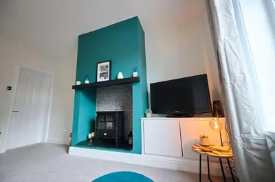 a living room with a fireplace and a television at 2 Bedroom House- Contractors - Families - Sleeps 4 in Great Harwood