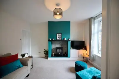 a living room with a couch and a fireplace at 2 Bedroom House- Contractors - Families - Sleeps 4 in Great Harwood