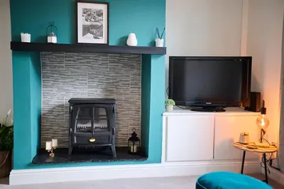 a living room with a fireplace and a tv at 2 Bedroom House- Contractors - Families - Sleeps 4 in Great Harwood