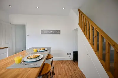 a dining table with two plates of food on it at 2 Bedroom House- Contractors - Families - Sleeps 4 in Great Harwood