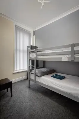 a bedroom with two bunk beds and a window at The Ocean Inn in Blackpool