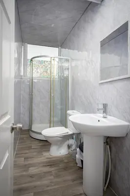 a white bathroom with a sink and a toilet at The Ocean Inn in Blackpool