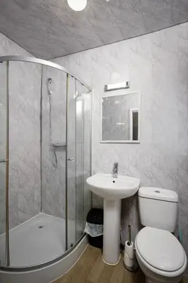 a bathroom with a toilet and a sink and a shower at The Ocean Inn in Blackpool
